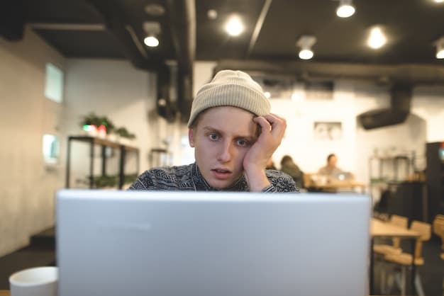 A close-up of a worried person looking at a laptop screen displaying error messages and security warnings. The background is intentionally blurred to emphasize the person's distress.