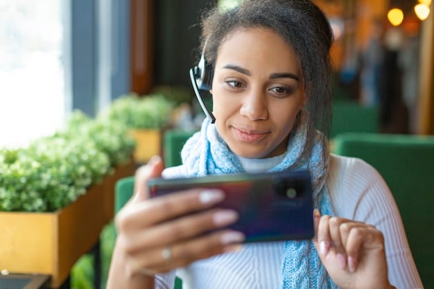 A person smiling while video chatting with a customer service representative on their smartphone. The background shows a modern office environment, emphasizing the professional and approachable nature of mobile customer support.