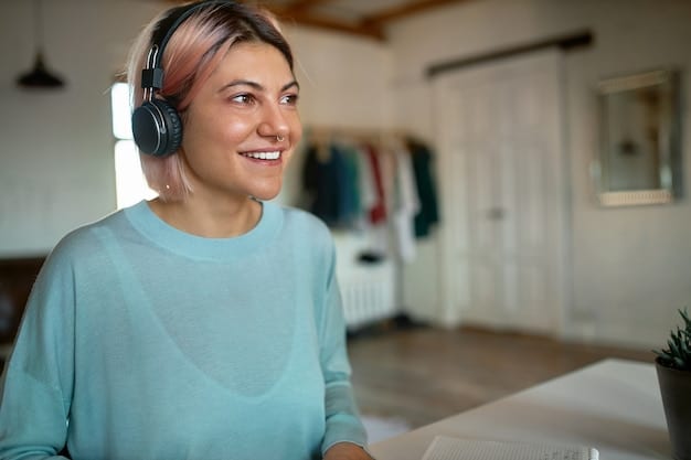 A customer service representative is smiling warmly while assisting a customer on a video call, both appearing satisfied and connecting well. The representative's headset is visible, and the background shows a tidy, professional home office setting with a laptop in focus.