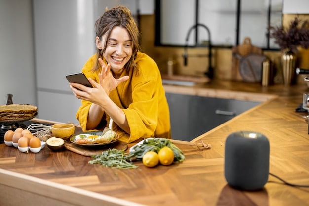 A person speaking to a smart speaker in their kitchen, with options for online groceries displayed on a tablet nearby. The scene illustrates the convenience and integration of voice commerce in daily life.